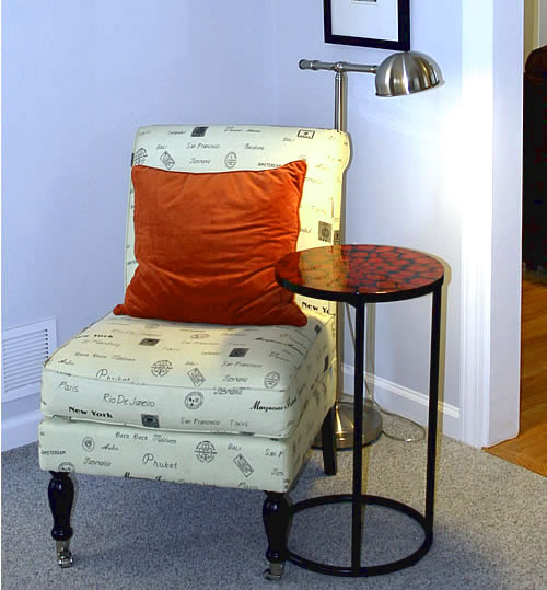 HomeGoods accent chair with orange pillow