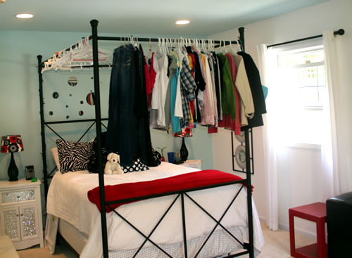 clothes hanging on canopy bed