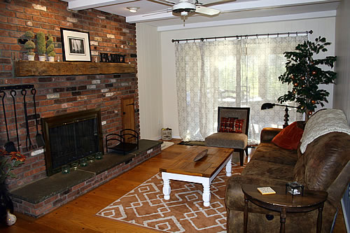 small narrow family room with brick red and orange rug