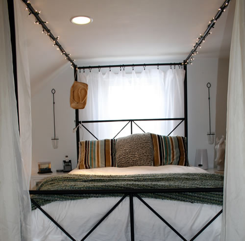 canopy bed in romantic country attic bedroom