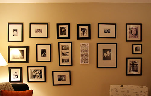 family photos arranged on living room wall