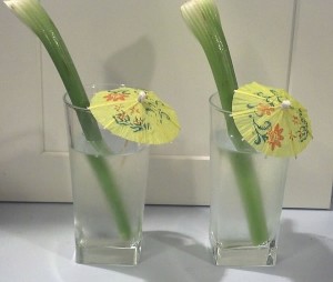 cucumber water with celery and cocktail umbrellas