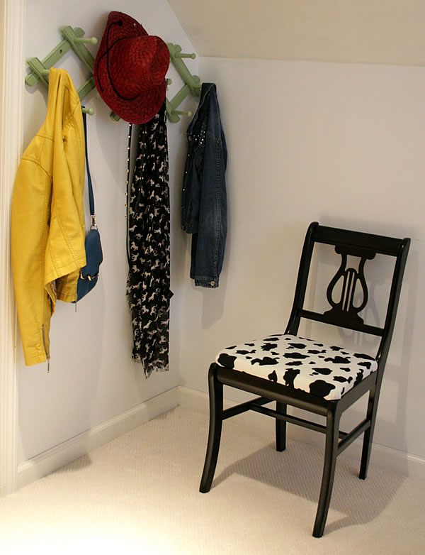 chair upcycled with black paint and cow print fabric