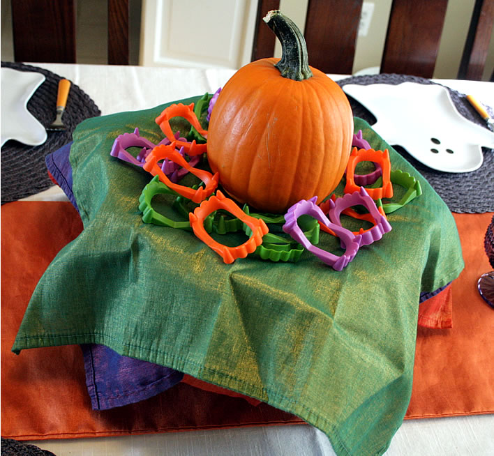 halloween colorful napkins and pumpkin on cake stand